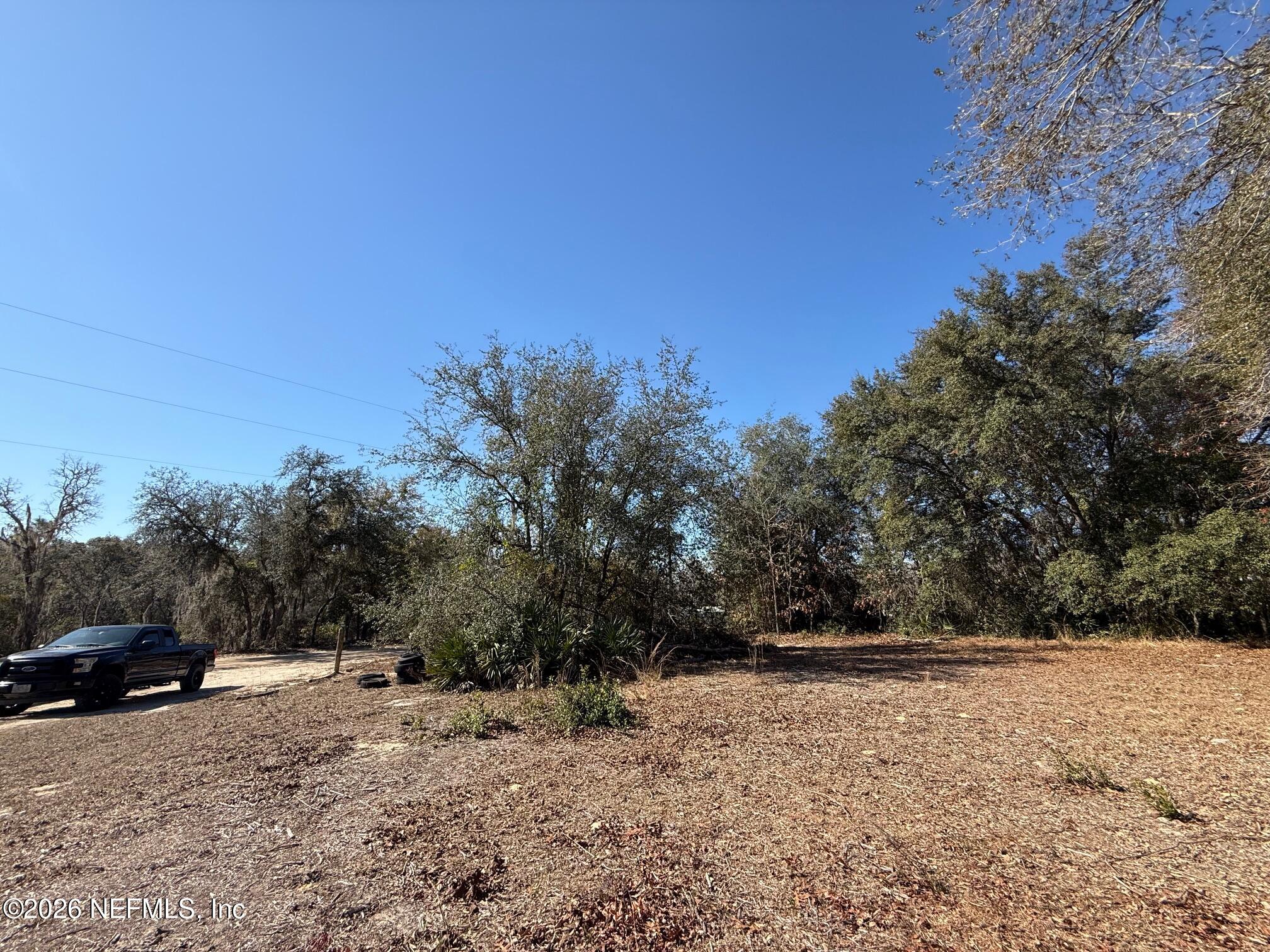 104 Churchill Street Interlachen, FL 32148 - Photo 24 of 24 a view of dirt road with a building in the background