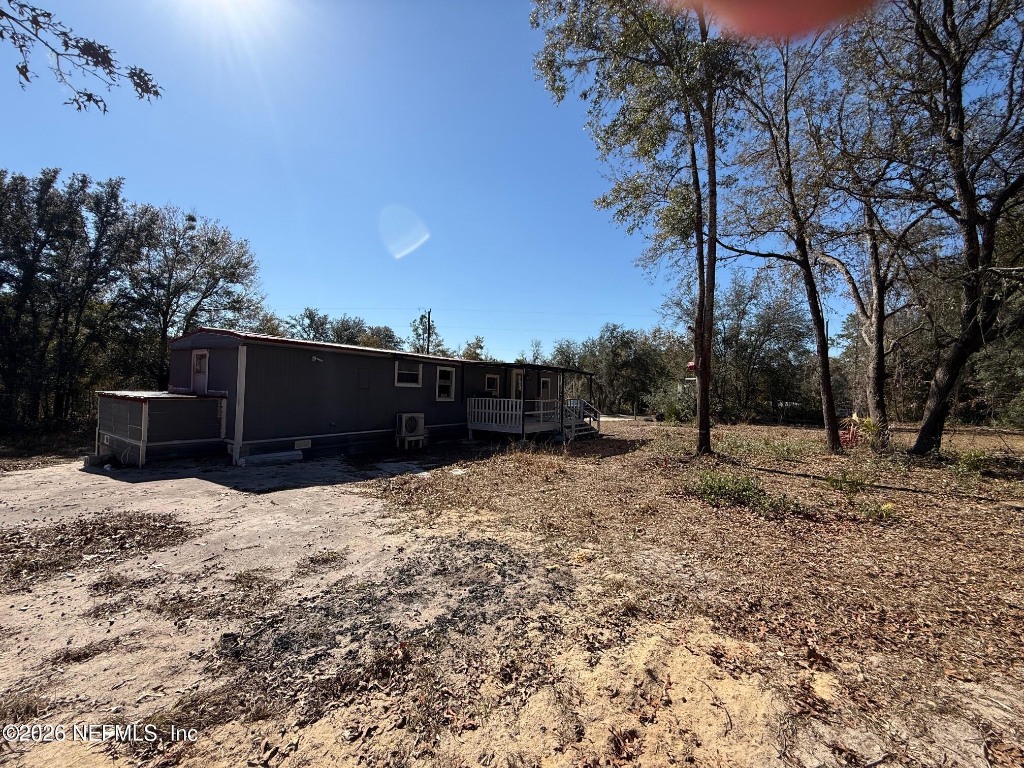 104 Churchill Street Interlachen, FL 32148 - Photo 8 of 24 a street view with wooden fence and trees