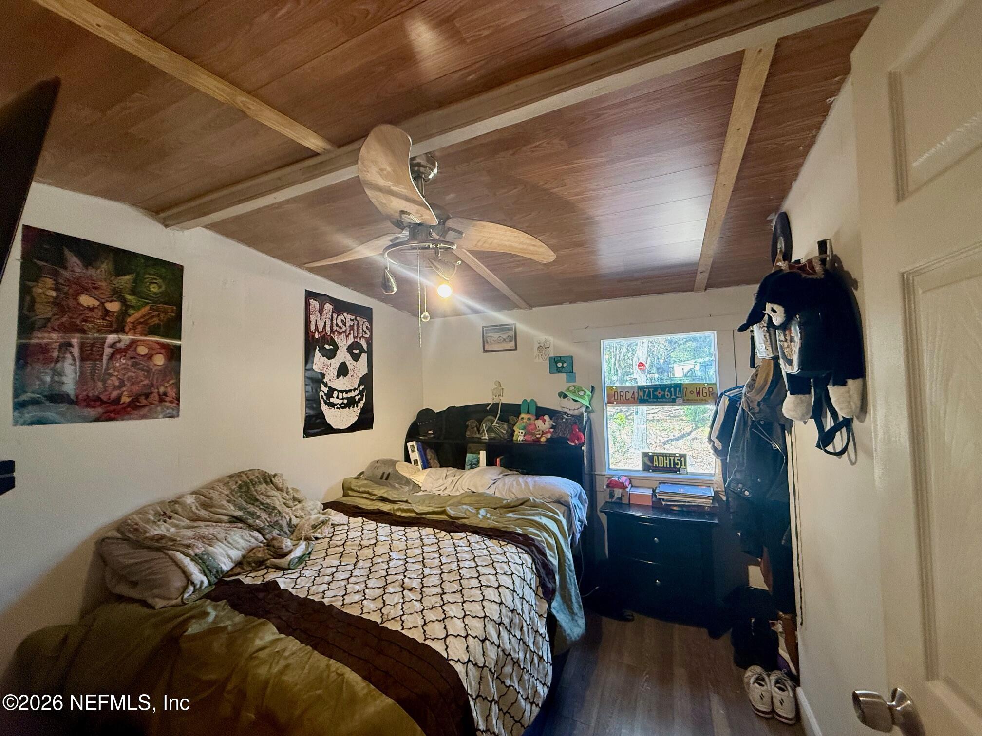 104 Churchill Street Interlachen, FL 32148 - Photo 10 of 24 a bedroom with a bed and a mirror