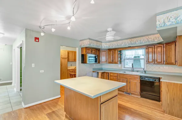 a kitchen with a stove a refrigerator and a sink