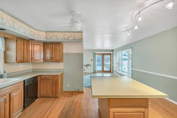 a kitchen with a wooden floor and window