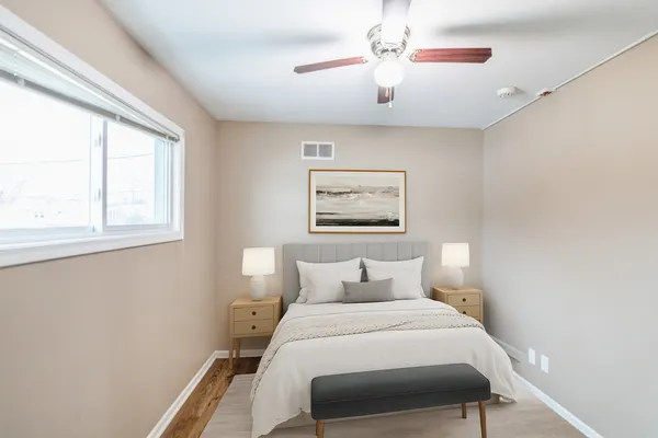 a bedroom with a bed and a painting on the wall