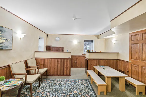a room with table chairs and wooden floor