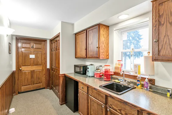 a kitchen with a sink cabinets and a window