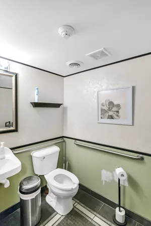 a white toilet sitting next to a bathroom sink