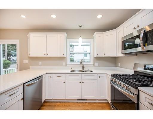 19 Laconia Avenue Saugus, MA 01906 - Photo 6 of 27 a kitchen with stainless steel appliances granite countertop a sink a stove a microwave a counter top and cabinets
