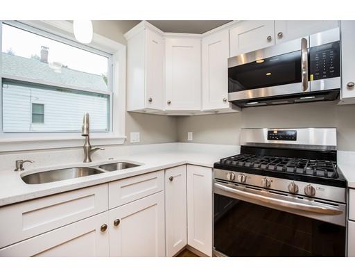 19 Laconia Avenue Saugus, MA 01906 - Photo 8 of 27 a kitchen with stainless steel appliances granite countertop a sink a stove and microwave