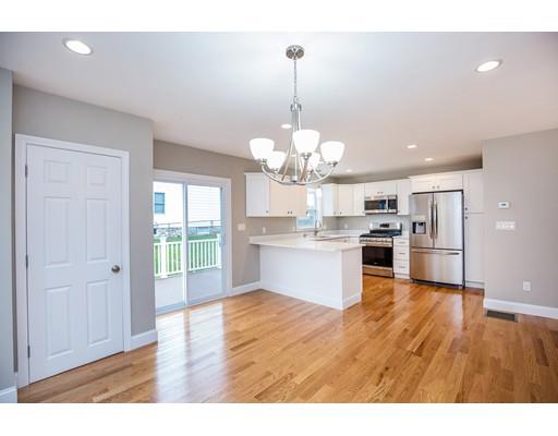19 Laconia Avenue Saugus, MA 01906 - Photo 9 of 27 a open kitchen with a refrigerator a stove a sink dishwasher and white cabinets with wooden floor