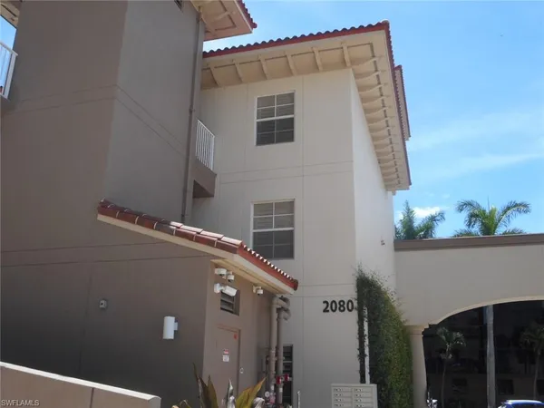 a dining room with furniture and a chandelier