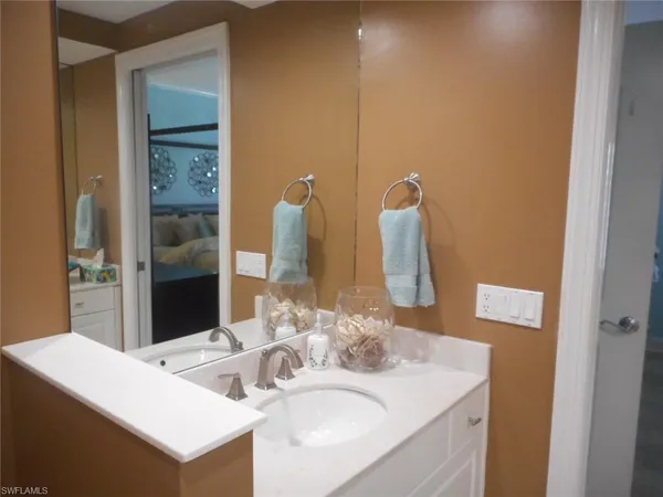 a kitchen with granite countertop white cabinets and black appliances