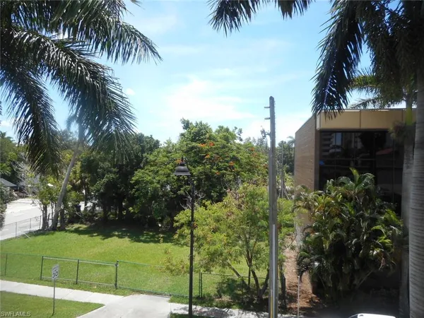 a view of a balcony with chair and wooden floor
