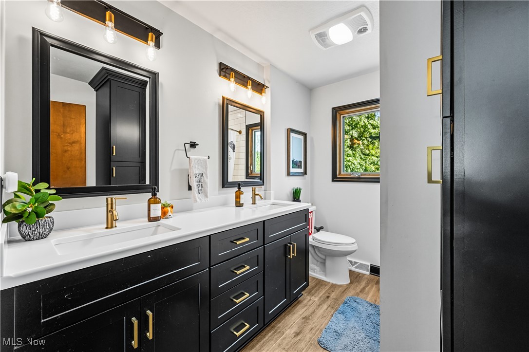 8193 Hartman Road Wadsworth, OH 44281 - Photo 21 of 50 Full bathroom with light wood-type flooring and double vanity