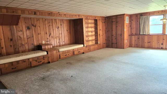 a view of an empty room with a fireplace and a window