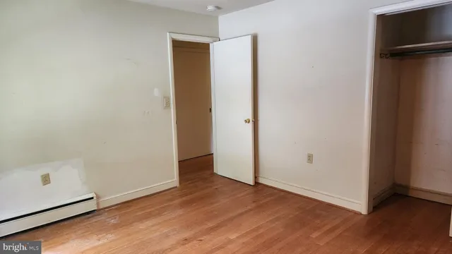 a view of a room with wooden floor
