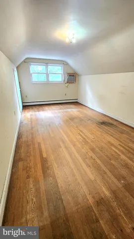 a room with water heater and wooden racks
