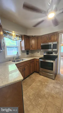 a kitchen with wooden cabinets a sink and a stove