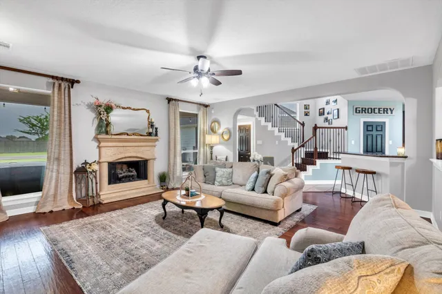 a living room with furniture a fireplace and a flat screen tv
