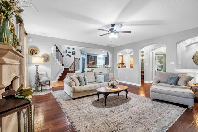 a living room with furniture and a wooden floor