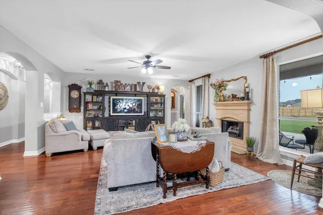 a living room with fireplace furniture and a wooden floor