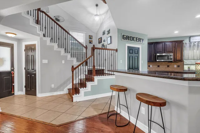 a view of entryway and hall with wooden floor