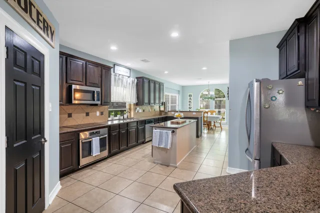 a large kitchen with stainless steel appliances lots of counter space