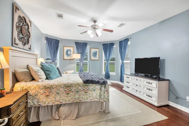 a bedroom with a bed and a flat screen tv