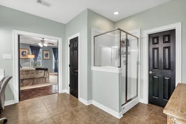 a view of a bathroom with tub and shower