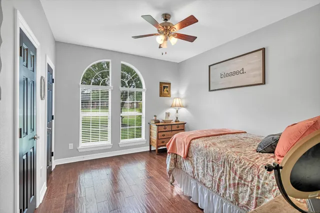 a bedroom with a large bed and a large window