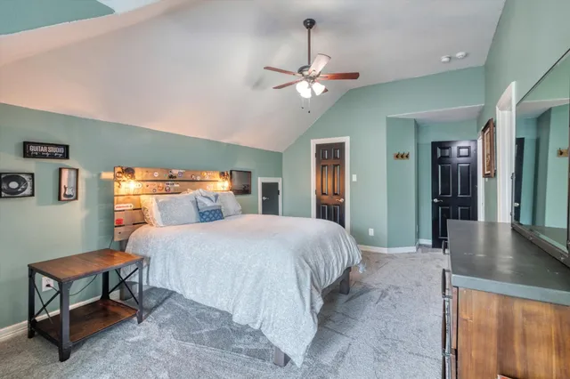 a bedroom with a large bed and a chandelier