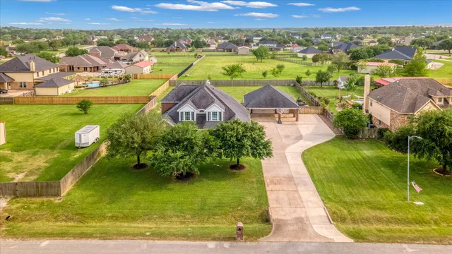 an aerial view of residential houses with outdoor space and city view