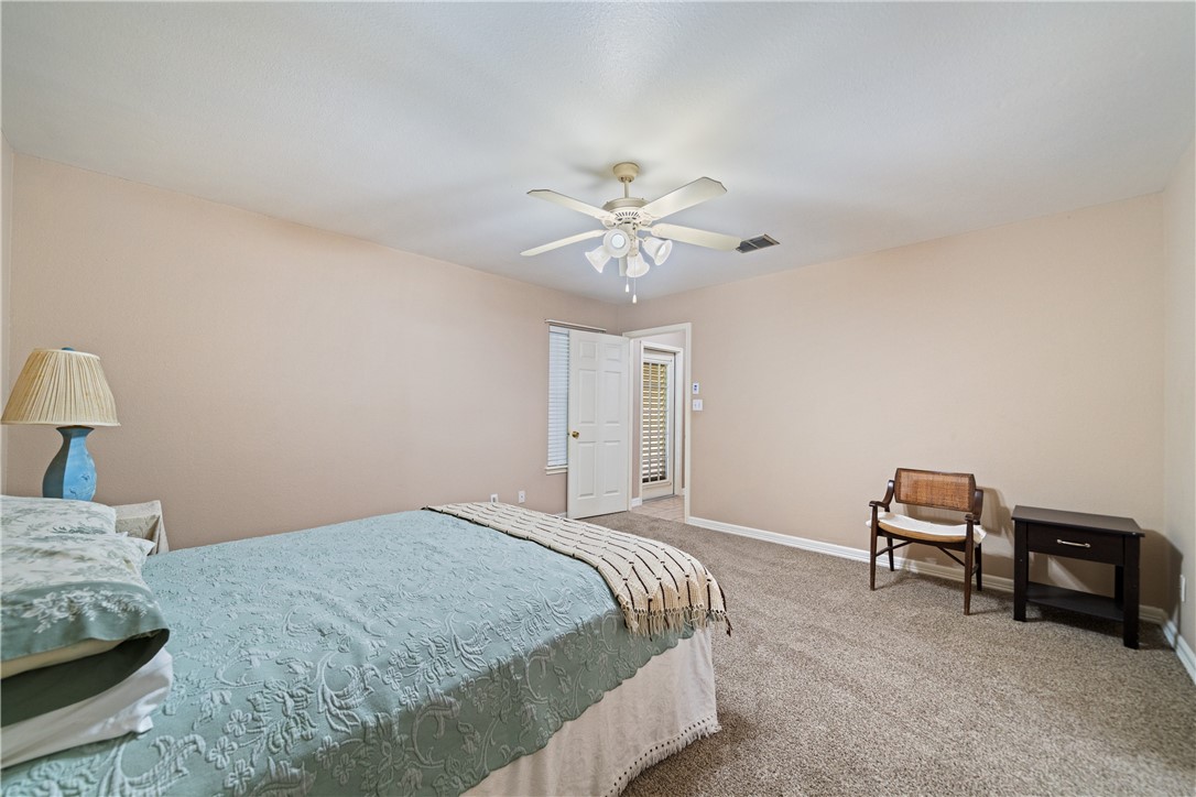 2839 McKinzie Road, Unit 10 Corpus Christi, TX 78410 - Photo 11 of 22 a bedroom with a bed and a chandelier