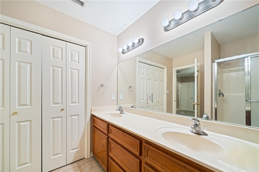 2839 McKinzie Road, Unit 10 Corpus Christi, TX 78410 - Photo 13 of 22 a bathroom with double vanity sink a mirror and a shower