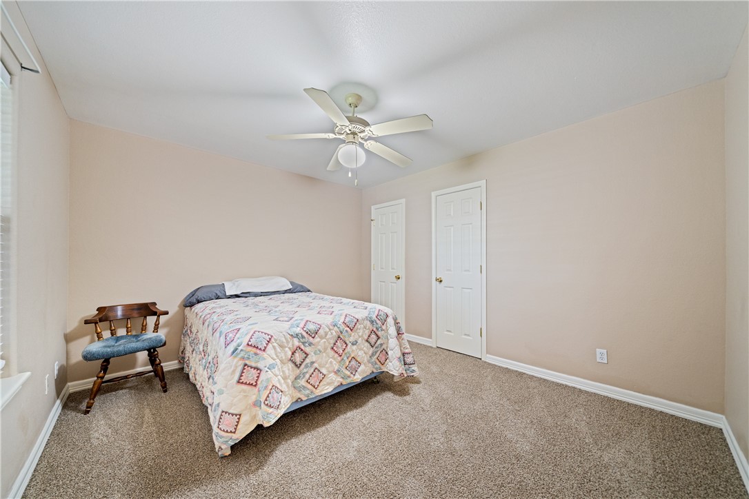 2839 McKinzie Road, Unit 10 Corpus Christi, TX 78410 - Photo 15 of 22 a bedroom with a bed and a ceiling fan