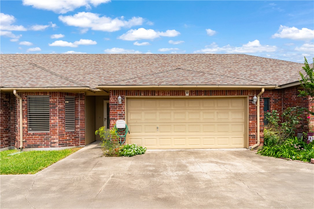 2839 McKinzie Road, Unit 10 Corpus Christi, TX 78410 - Photo 2 of 22 a front view of a house with a garden and garage