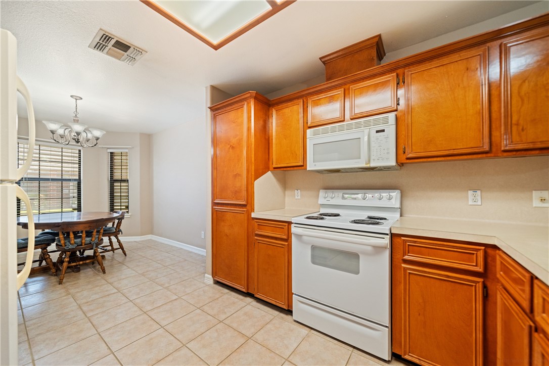 2839 McKinzie Road, Unit 10 Corpus Christi, TX 78410 - Photo 6 of 22 a kitchen with a stove and cabinets