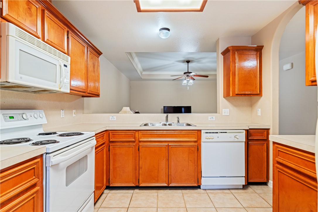 2839 McKinzie Road, Unit 10 Corpus Christi, TX 78410 - Photo 7 of 22 a kitchen with stainless steel appliances a stove a sink and a microwave