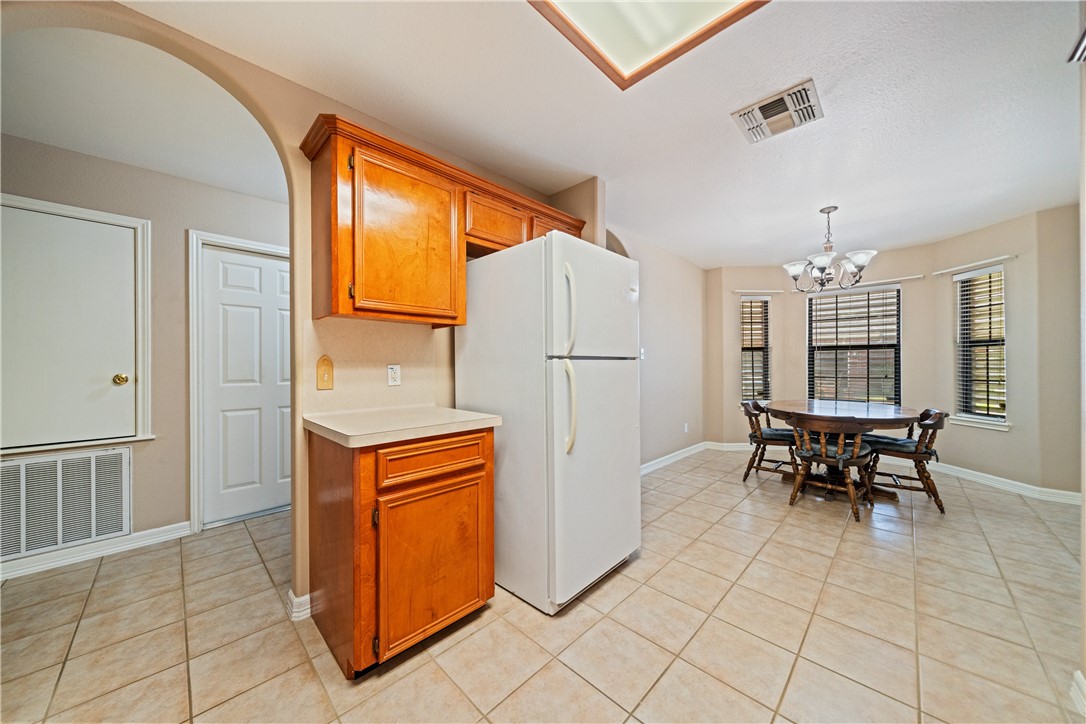 2839 McKinzie Road, Unit 10 Corpus Christi, TX 78410 - Photo 8 of 22 a kitchen with granite countertop cabinets and refrigerator