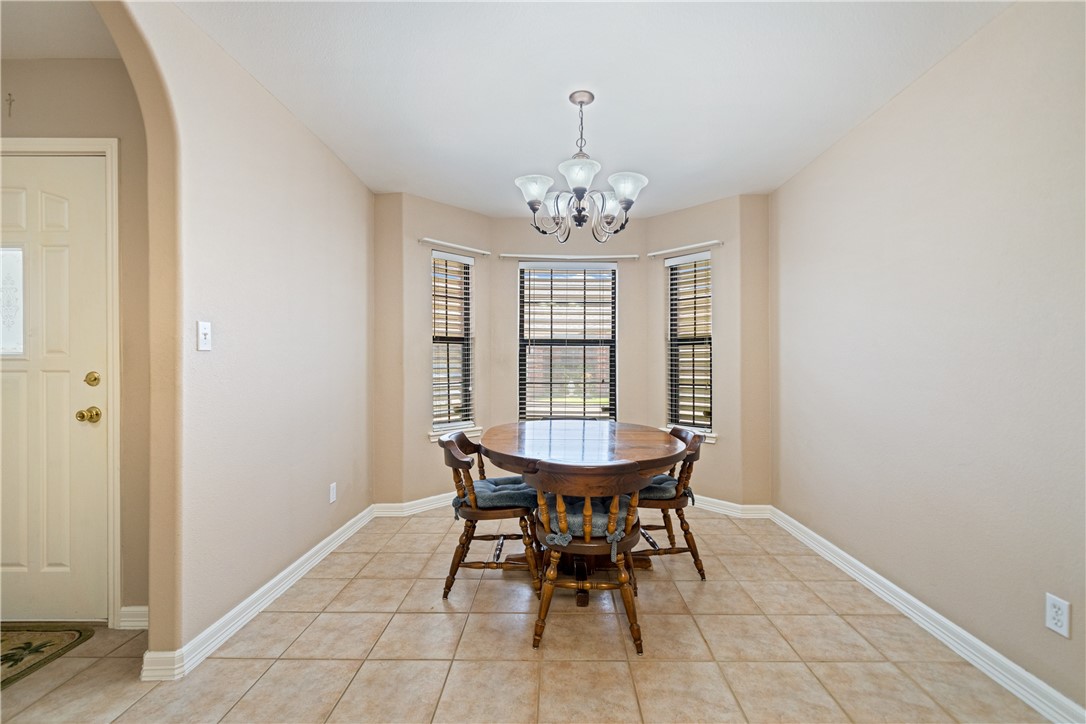 2839 McKinzie Road, Unit 10 Corpus Christi, TX 78410 - Photo 9 of 22 a view of a dining room with furniture and chandelier