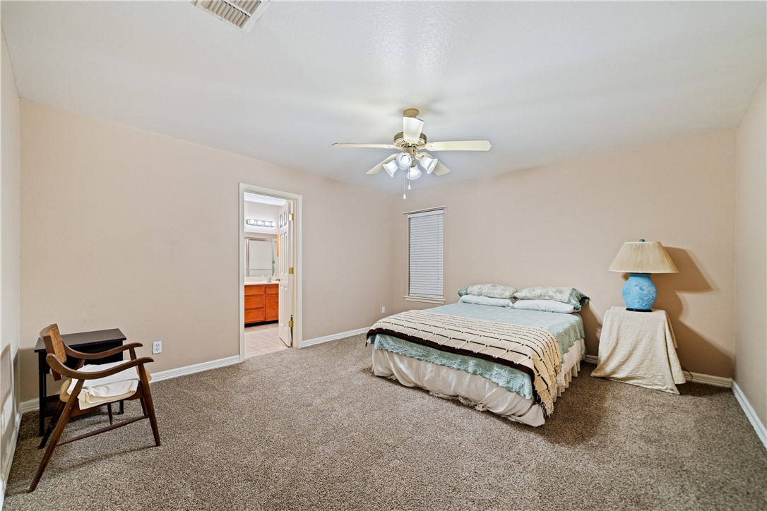 2839 McKinzie Road, Unit 10 Corpus Christi, TX 78410 - Photo 10 of 22 a spacious bedroom with a bed and a chandelier