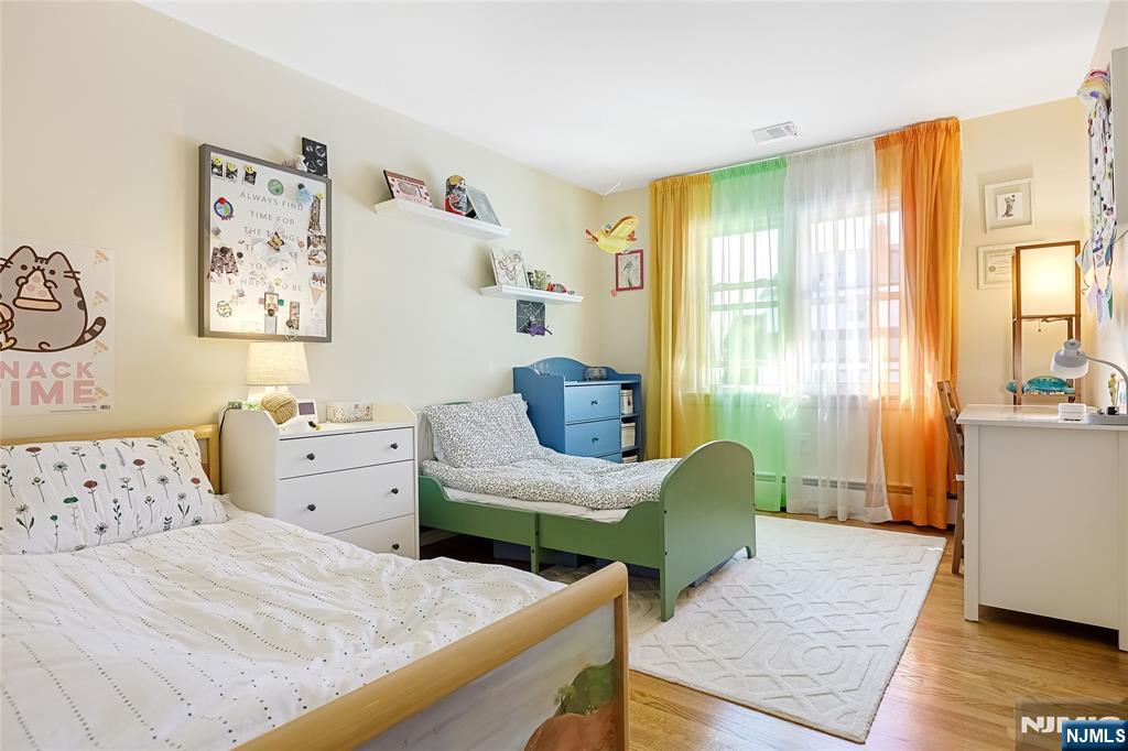 193 Prospect Place Rutherford, NJ 07070 - Photo 11 of 37 a bedroom with furniture and a large window