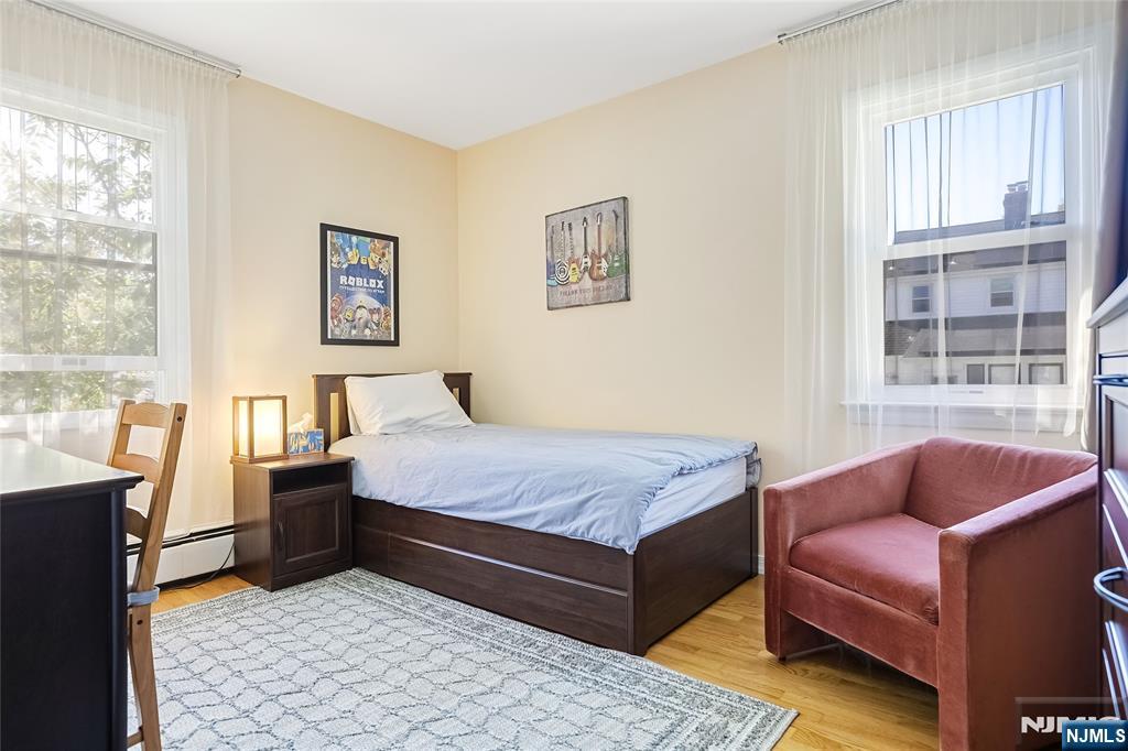 193 Prospect Place Rutherford, NJ 07070 - Photo 13 of 37 a bedroom with a bed and wooden floor