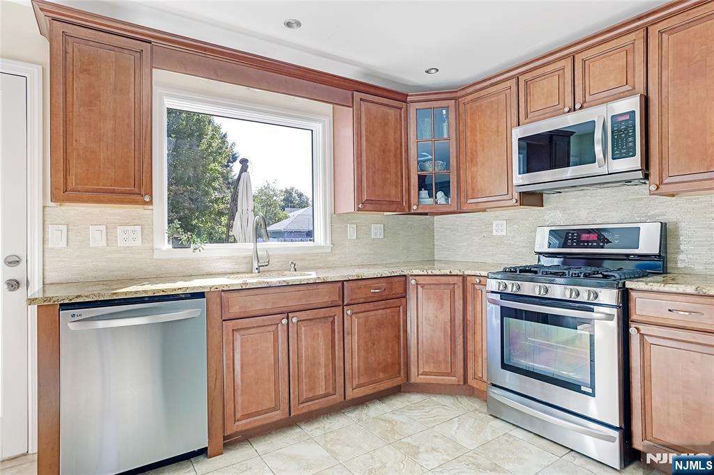 193 Prospect Place Rutherford, NJ 07070 - Photo 14 of 37 a kitchen with stainless steel appliances granite countertop a stove sink and microwave