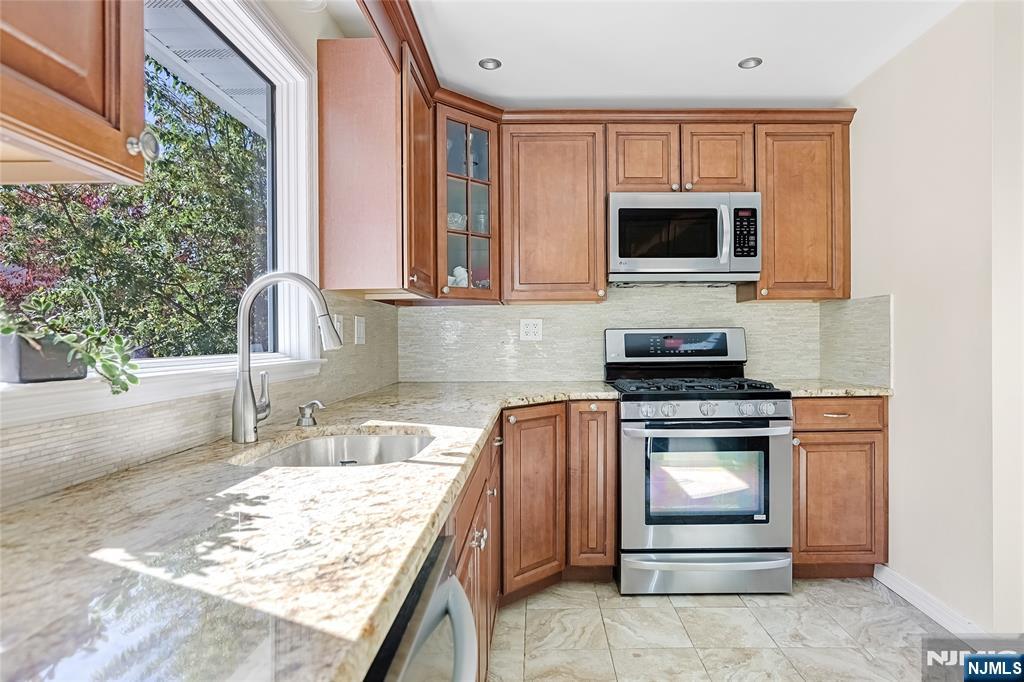 193 Prospect Place Rutherford, NJ 07070 - Photo 15 of 37 a kitchen with stainless steel appliances granite countertop a sink stove and microwave