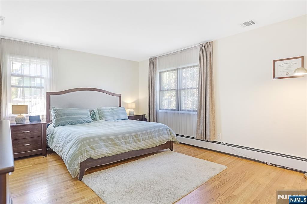 193 Prospect Place Rutherford, NJ 07070 - Photo 16 of 37 a bedroom with a bed and wooden floor
