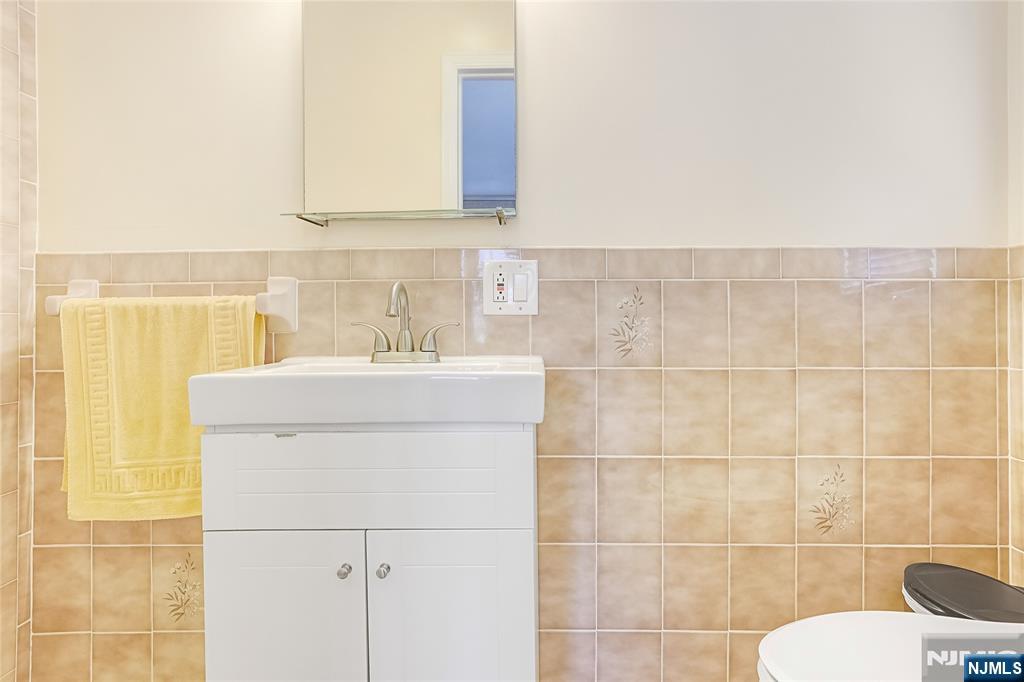 193 Prospect Place Rutherford, NJ 07070 - Photo 19 of 37 a bathroom with a sink a toilet and a mirror