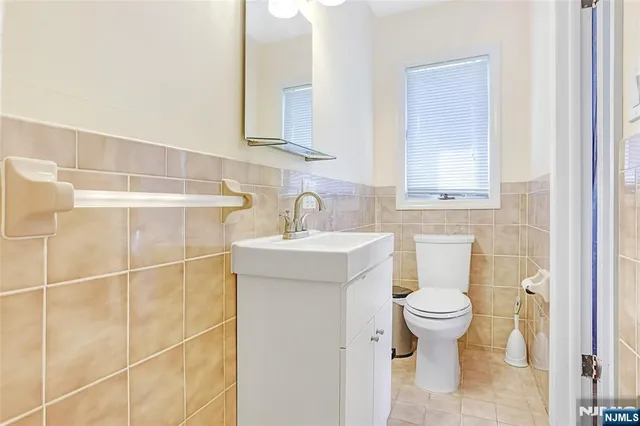 a bathroom with a sink a toilet and mirror