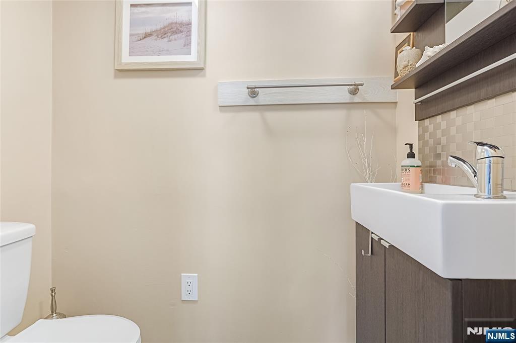 193 Prospect Place Rutherford, NJ 07070 - Photo 24 of 37 a bathroom with a sink mirror and toilet