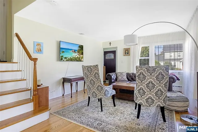 a living room with furniture a dining table and wooden floor