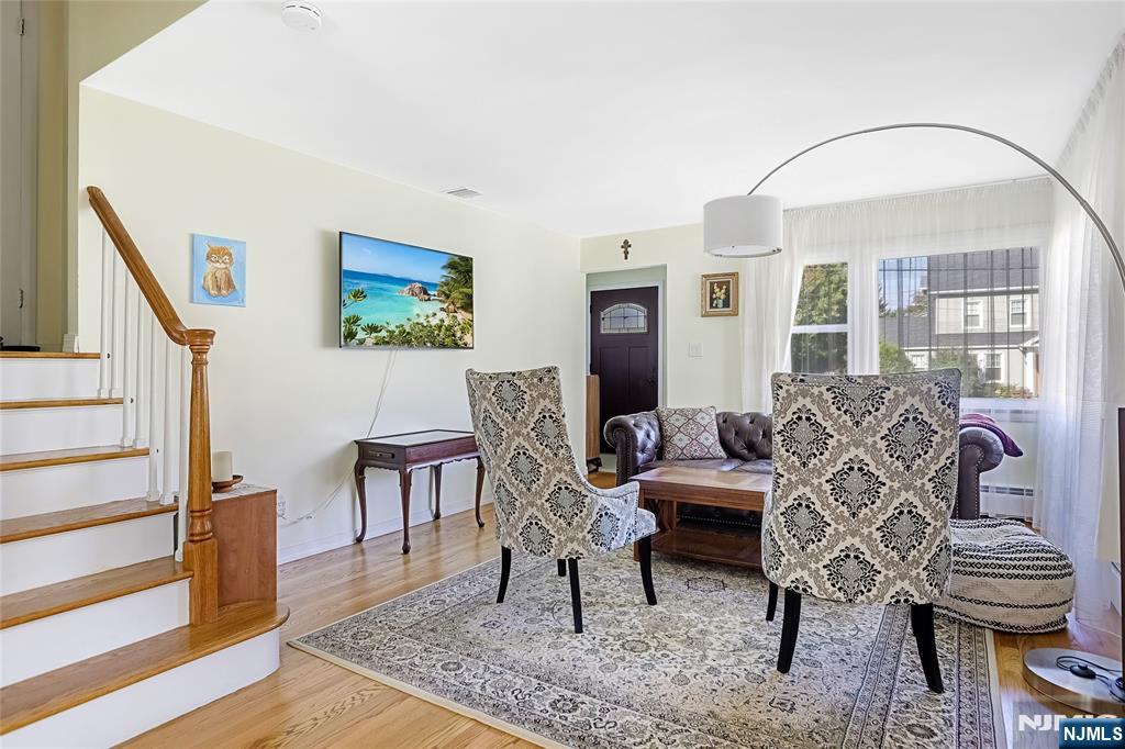193 Prospect Place Rutherford, NJ 07070 - Photo 3 of 37 a living room with furniture a dining table and wooden floor