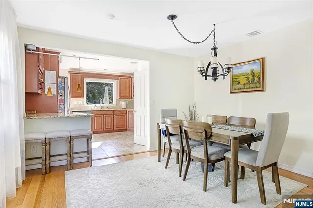 a view of a dining room with furniture and a chandelier